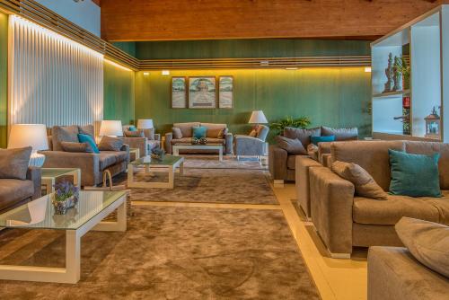 una gran sala de estar con sofás y mesas. en Hotel Talaso Louxo La Toja, en Isla de la Toja