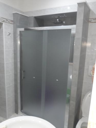 a bathroom with a toilet and a glass door at chicchinella in Altamura