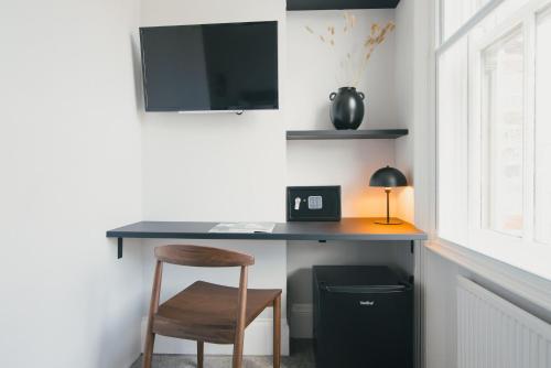 a desk in a room with a chair and a table at D8 - Shoreditch in London