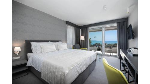 a hotel room with a bed and a balcony at Boutique Hotel Mirjam in Makarska