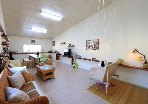 a living room with a couch and a swing at Gods Home in Checheng