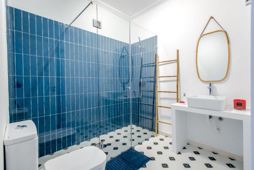 a bathroom with a toilet and a sink and a mirror at Sta Catarina - Cascais Beach Apartments in Cascais