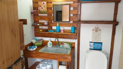 a bathroom with a sink and a toilet in a room at Mamas Summer House in Larnaka