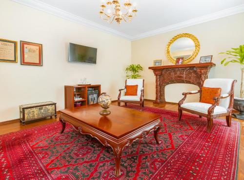 a living room with a table and chairs and a fireplace at Hotel Geneve CD de Mexico in Mexico City