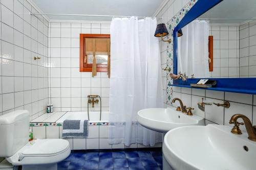 a bathroom with a tub and a toilet and a sink at Villa Loridis in Prinos