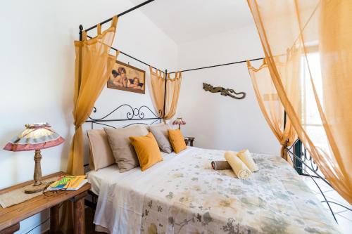 a bedroom with a bed and a desk with a lamp at Oasi Caprolace in Sabaudia