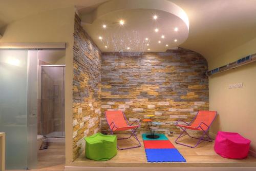 a room with two chairs and a brick wall at Navona Dream in Rome