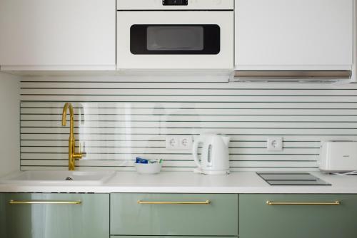 a kitchen with a sink and a microwave at Sta Catarina - Cascais Beach Apartments in Cascais