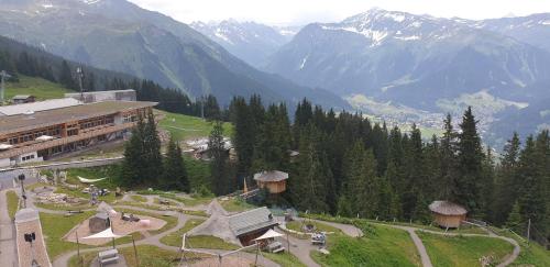 a view of a mountain with a building and mountains at Ferienhaus & Ferienwohnung Wiñay Wayna Gotschna Blick Klosters in Klosters Serneus