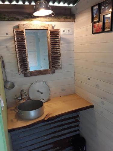 a small bathroom with a sink and a mirror at Camping Le Pré du Lac Pagéas in Pagéas