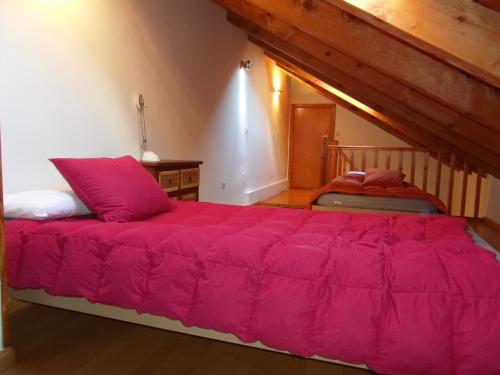 a bedroom with a large pink bed in a room at B16 - Edif Ball Benás Dúplex - Villmor in Benasque