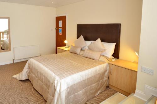 a bedroom with a large bed in a room at Stuart hotel in Blackpool