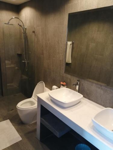 a bathroom with a toilet and a sink and a shower at Pearl Villa in Nathon