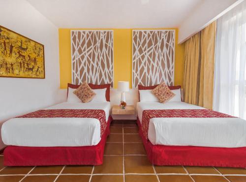 a hotel room with two beds and a window at Loreto Bay Golf Resort & Spa at Baja in Loreto