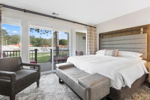 a bedroom with a large bed and a chair at Grand Geneva Resort and Spa in Lake Geneva