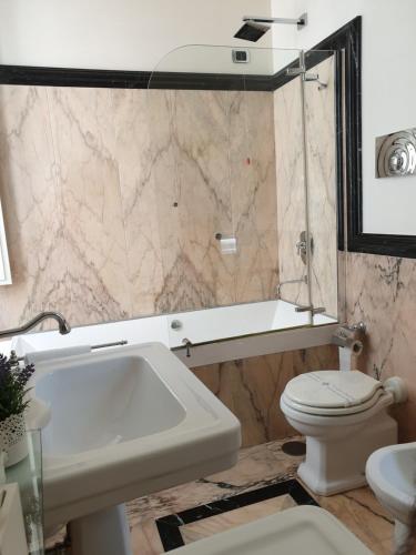 a bathroom with a sink and a toilet at Al centro Luxury Home in Caserta