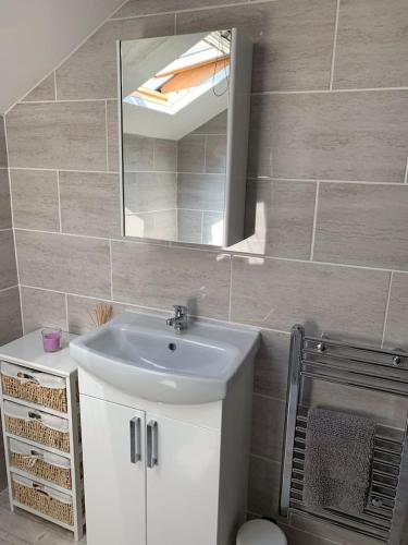 a bathroom with a sink and a mirror at 5 Harbour Lights in Penzance