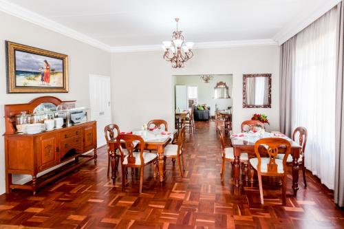 a dining room with a table and chairs at Adato Guesthouse in Potchefstroom