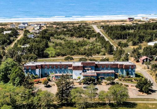 an aerial view of a building next to the ocean at Chateau Westport in Westport
