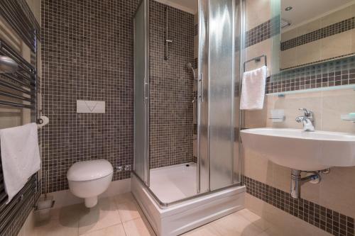 a bathroom with a shower and a sink and a toilet at Villa Natalia in Neum