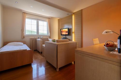 a small room with a bed and a desk in it at Villa Natalia in Neum
