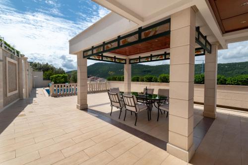 a patio with a table and chairs on a roof at Villa Natalia in Neum
