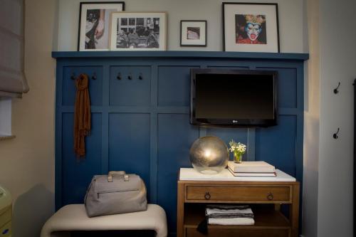 a room with a blue wall with a tv at Redford Hotel in New York