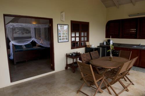 a kitchen and dining room with a table and chairs at Villa Touloulou in English Harbour Town