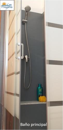 a shower with a shower head in a bathroom at Can Pinyana in Torreblanca