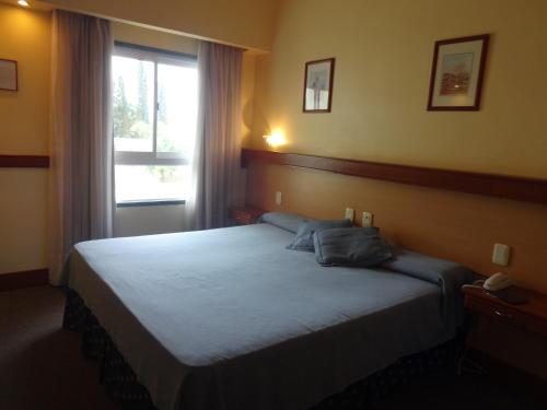 Säng eller sängar i ett rum på Hotel Plaza Rafaela