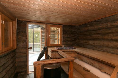 a log cabin with a desk and a window at Ankkalinna in Pyhätunturi