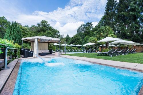 a swimming pool with a water slide at Hotel & Spa Cacciatori in Cademario