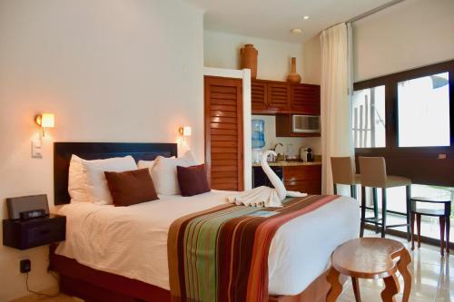 a bedroom with a bed with a swan on it at Playa Palms Beach Hotel in Playa del Carmen