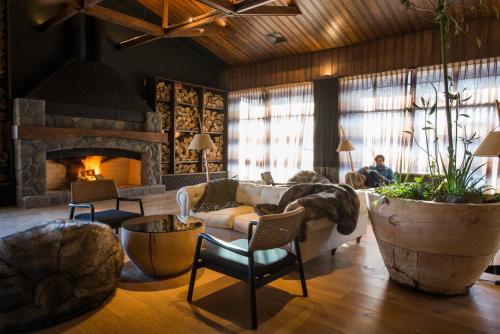 a living room with a couch and a fireplace at Hotel Termas Chillán in Nevados de Chillan