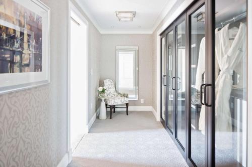 a hallway with a chair and a window at Boston Harbor Hotel in Boston