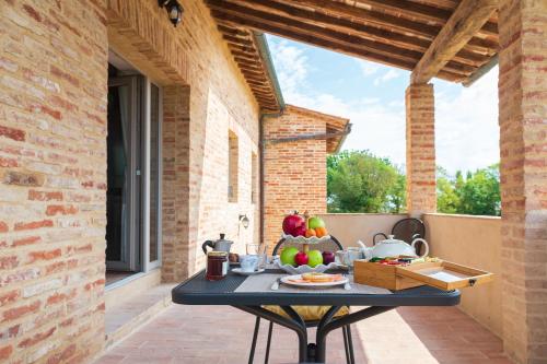 a table with fruit on it on a patio at Tenuta La Santissima in San Rocco a Pilli