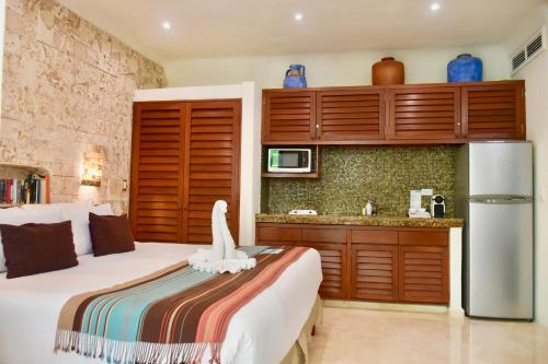 a bedroom with a bed with a white bird on it at Playa Palms Beach Hotel in Playa del Carmen