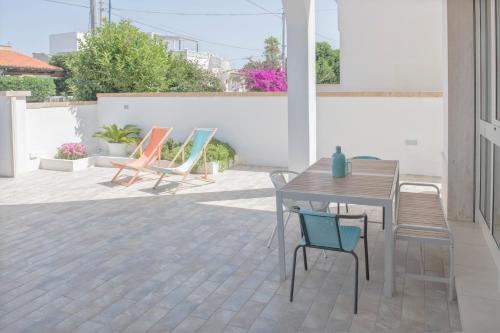 a patio with a table and chairs on a patio at Casa Te Mare in Torre Suda