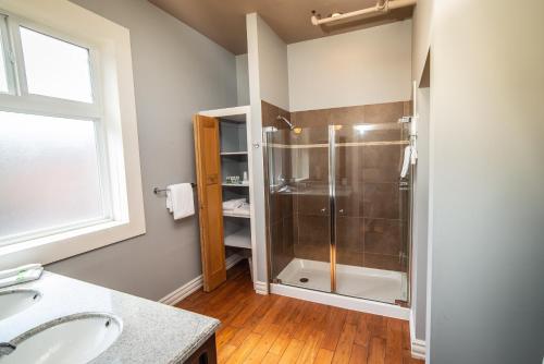 a bathroom with a shower and a sink at Adventure Hotel in Nelson