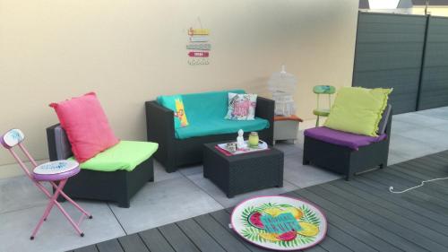 a room with three chairs and a table and a stool at La casita de Vanessa in Changé