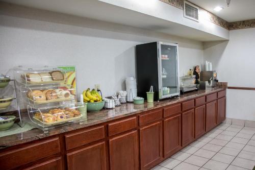a buffet line in a restaurant with bread and bananas at Quality Inn & Suites Loves Park near Rockford in Loves Park