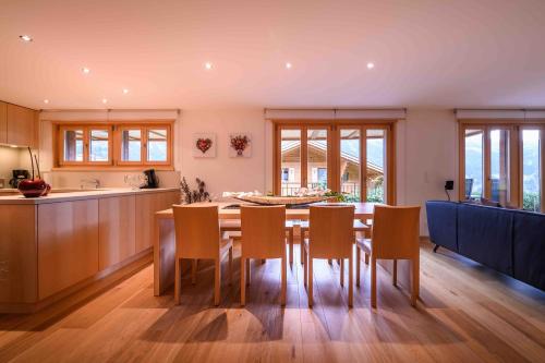 a kitchen and dining room with a table and chairs at Bisi in Grindelwald