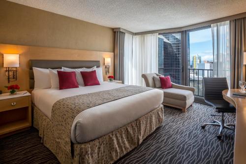 a hotel room with a large bed and a large window at Warwick Seattle in Seattle