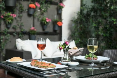 a table with plates of food and glasses of wine at Sofitel Beirut Le Gabriel in Beirut