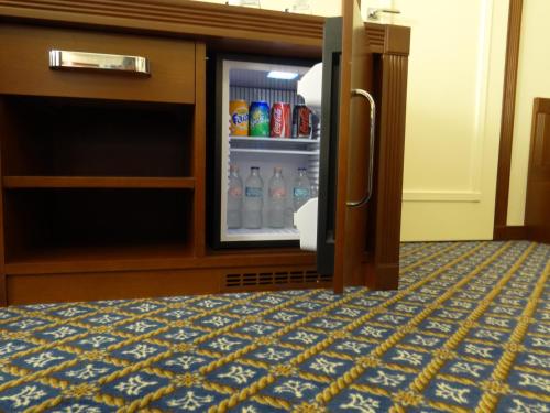 an open refrigerator with drinks inside of it at Centrum Hotel in Debrecen