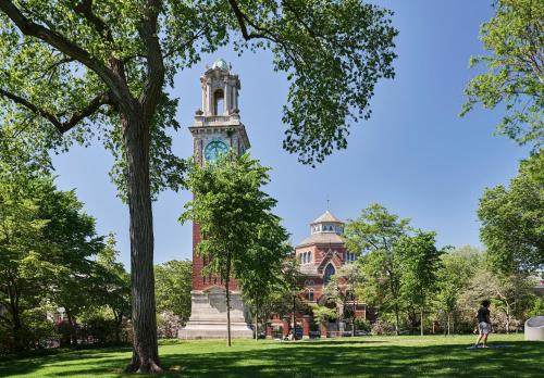 a building with a clock tower in the middle of a park at Graduate by Hilton Providence in Providence