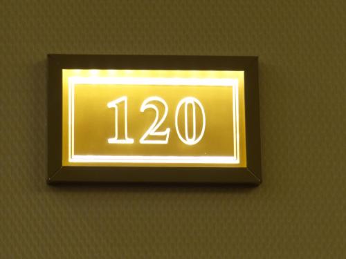 a neon sign on a wall with at Centrum Hotel in Debrecen