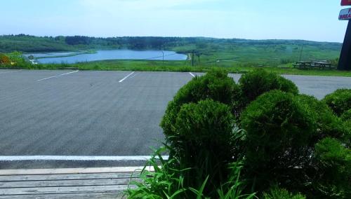 an empty parking lot with a lake in the background at Econo Lodge Inn & Suites in Saint John