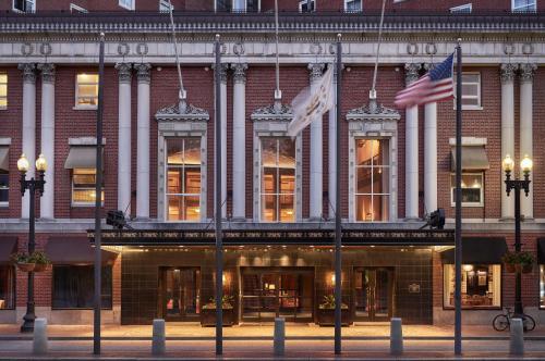 a building with two flags in front of it at Graduate by Hilton Providence in Providence