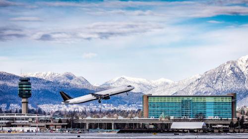 an airplane is taking off from an airport at Fairmont Vancouver Airport In-Terminal Hotel in Richmond